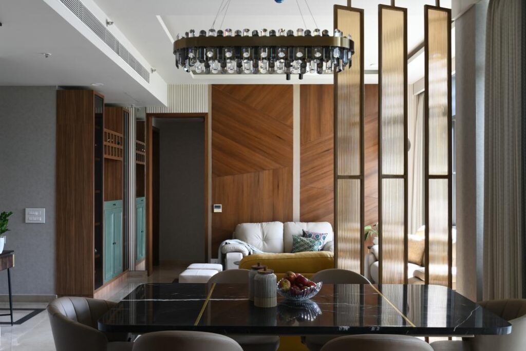Contemporary Living room Interiors with partial metal screen separating the Dining Area