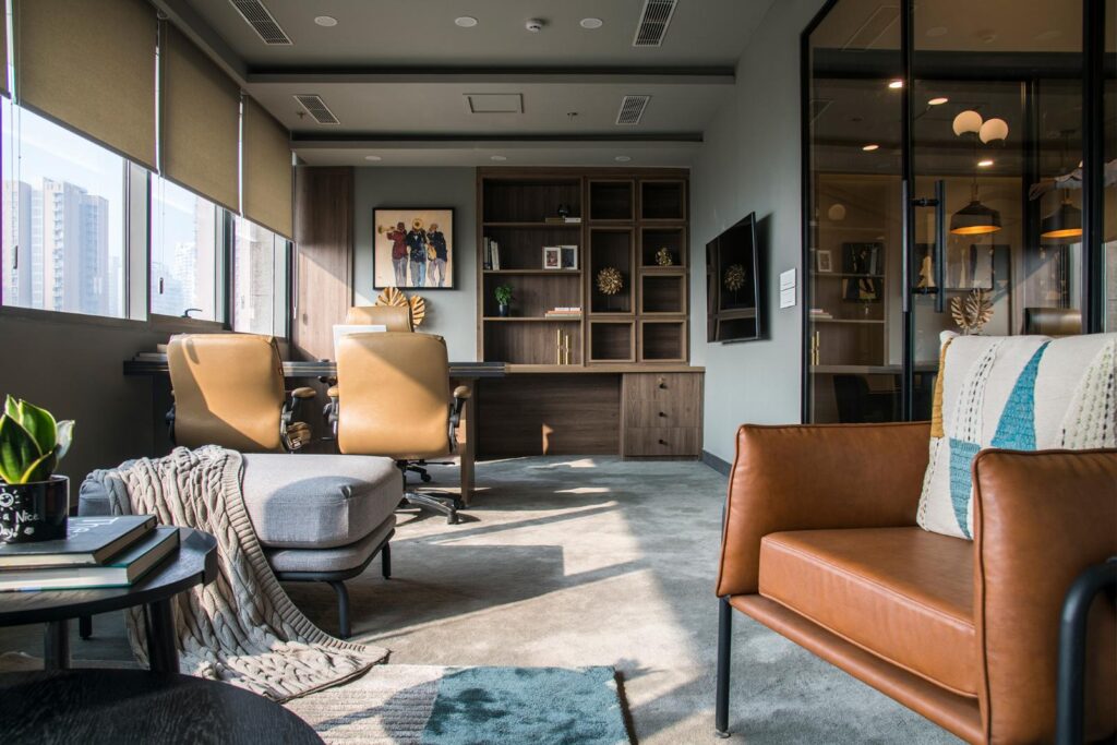 Modern Office Interiors with Wooden Accents and Grey Textures and leather Sofas